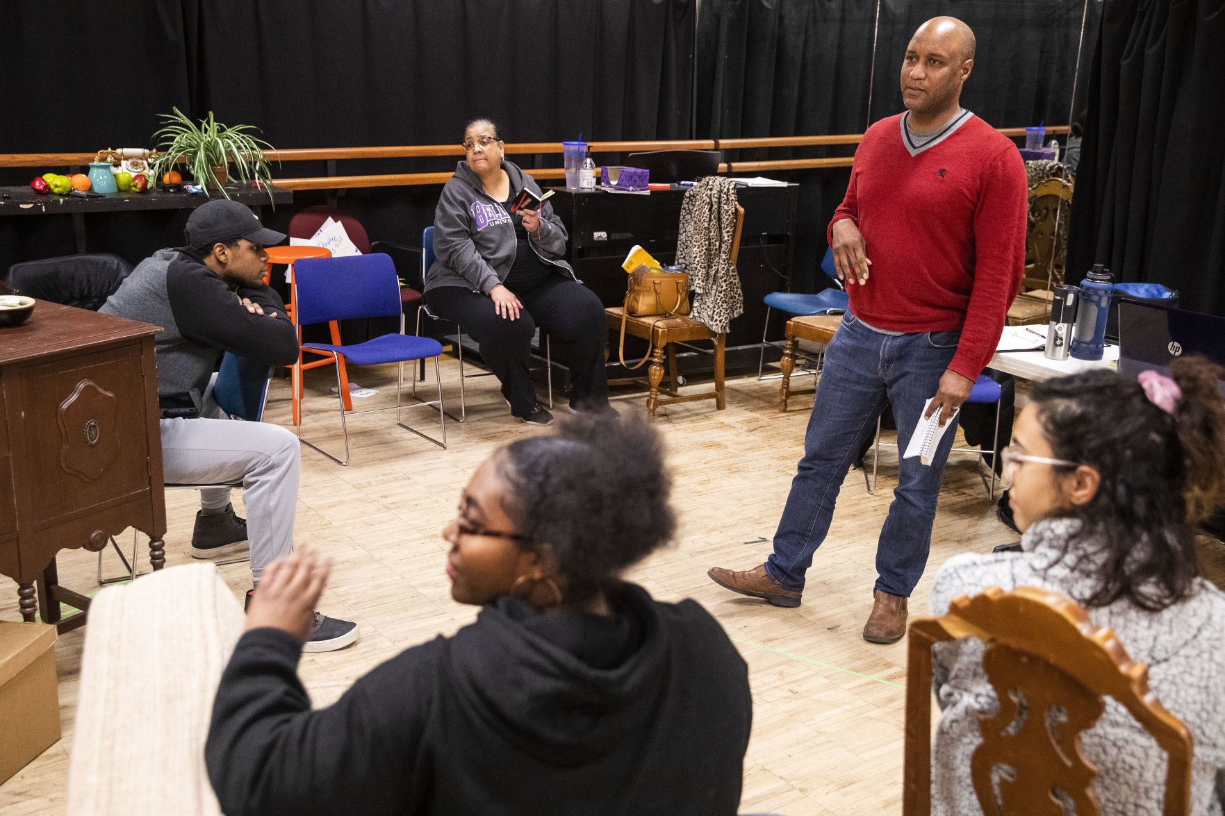Tyrone Beasley talks with cast members before rehearsal.